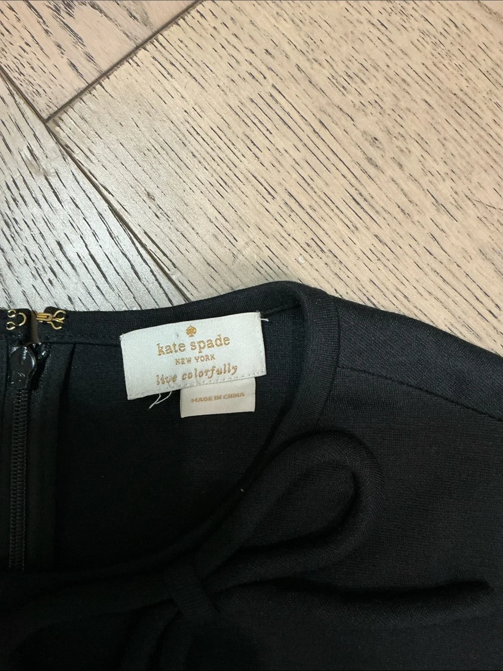 Woman’s kate spade black short sleeve top. Small-medium. Round neck with bow.